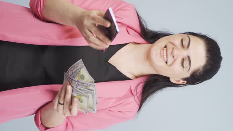 Vertical-video-of-Business-woman-shopping-on-the-phone-with-a-credit-card.